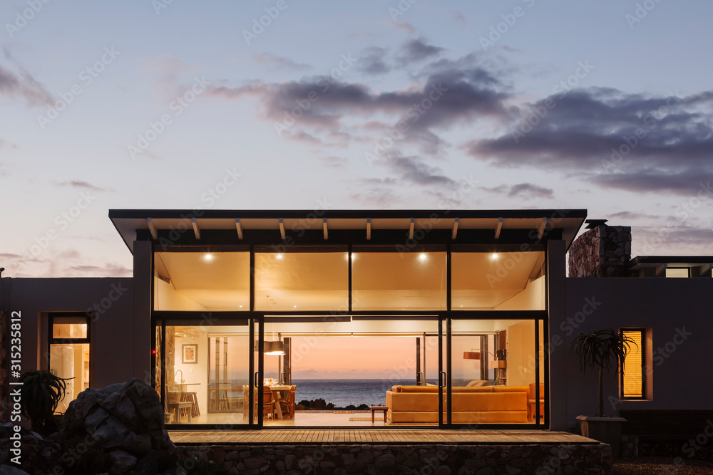 Illuminated luxury home under sky at dusk Illuminated luxury home under sky at dusk