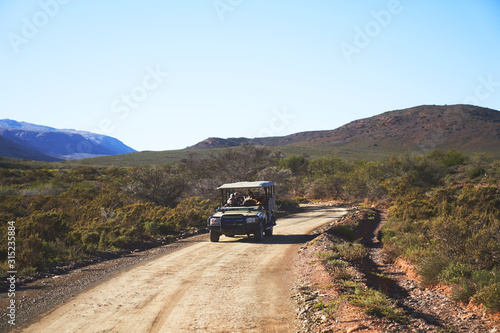 Safari off-road vehicle on sunny emote dirt road South Africa