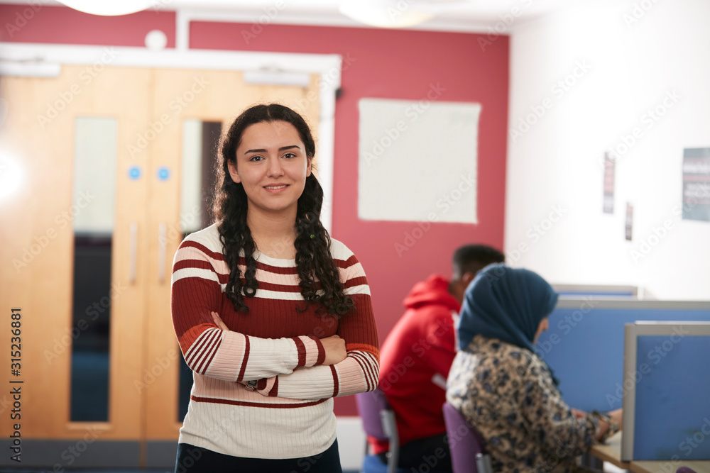 Portrait confident young female college student in library Portrait confident young female college student in library