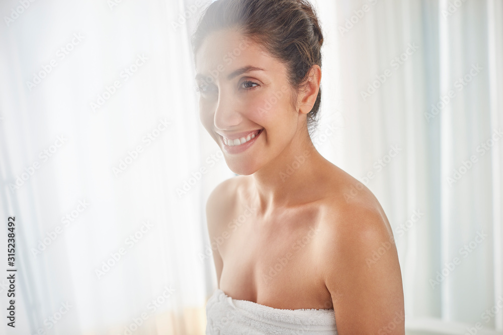 Smiling woman wrapped in towel Smiling woman wrapped in towel