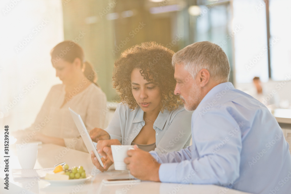 Business people drinking coffee and using digital tablet Business people drinking coffee and using digital tablet