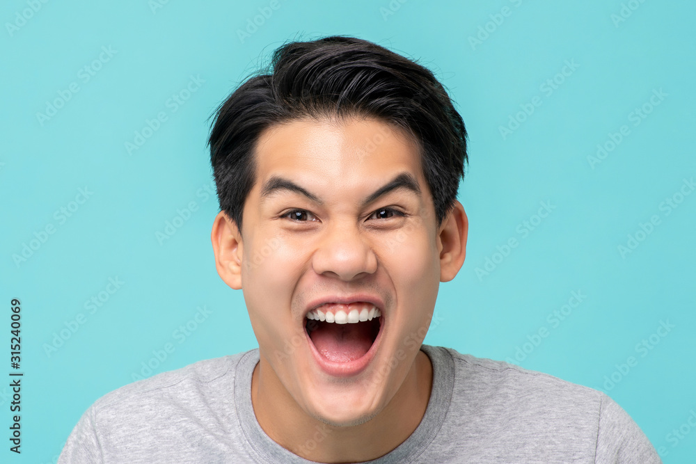 Delighted excited Asian man face Delighted excited Asian man face