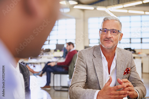 Businessmen talking in meeting