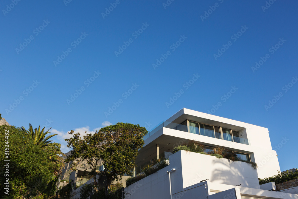 Modern luxury white home showcase exterior under blue sky Modern luxury white home showcase exterior under blue sky