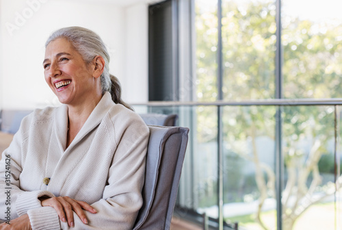 Mature woman laughing, looking away