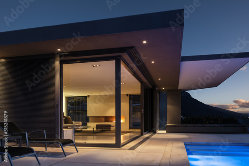 Illuminated modern home showcase exterior at night photo