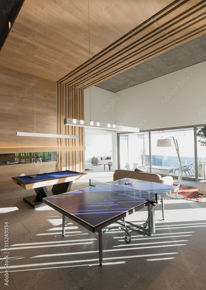 Pool table and ping pong table in modern, luxury home showcase interior ...