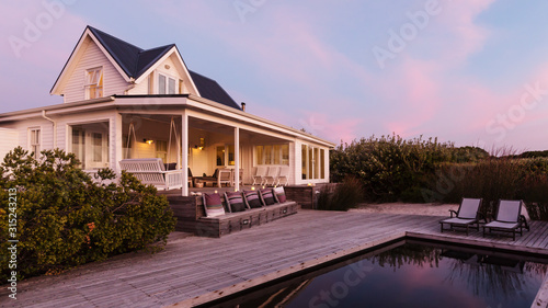 White home showcase exterior beach house at dusk