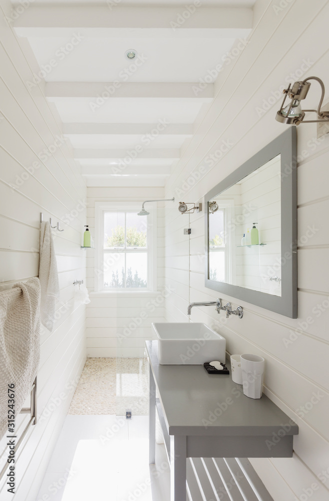 © Martin Barraud/Caia Image - Long, sunny white modern luxury bathroom