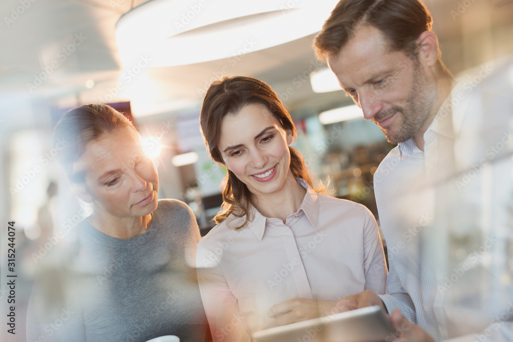 Business people using digital tablet in office Business people using digital tablet in office
