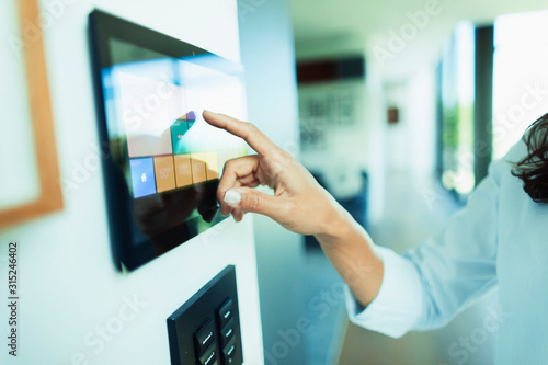 Close up woman at home automation touch screen panel