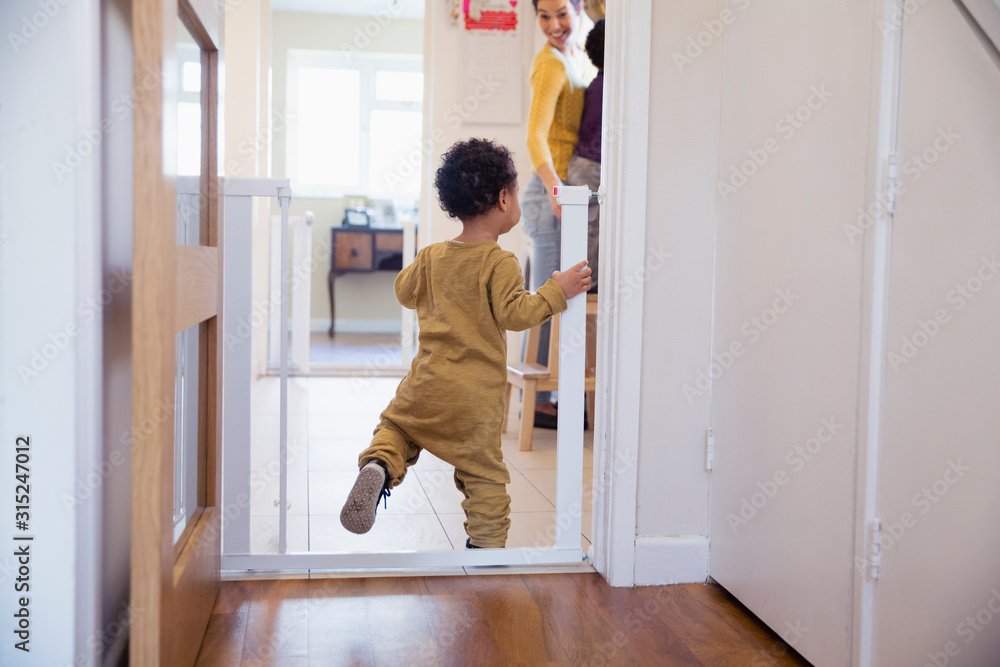 Cute baby boy balancing in doorway Cute baby boy balancing in doorway