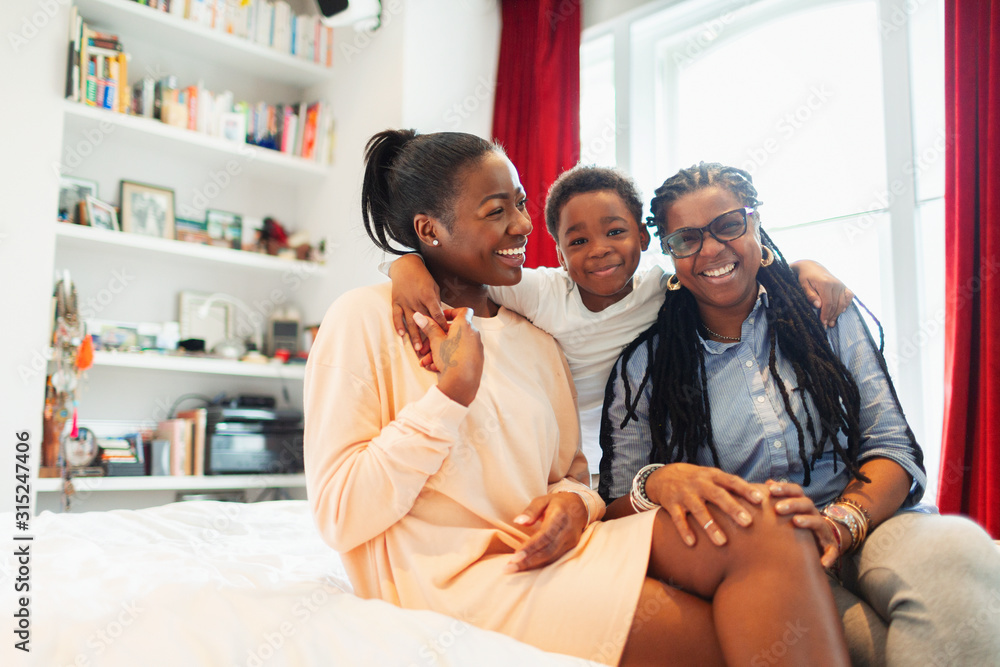 Portrait happy multi-generation family hugging on bed Portrait happy multi-generation family hugging on bed
