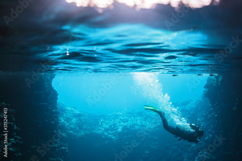 Woman scuba diving underwater, Vava'u, Tonga, Pacific Ocean photo
