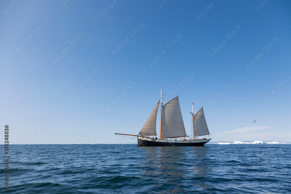 Ship sailing on sunny blue arctic Atlantic Ocean Greenland Ship sailing on sunny blue arctic Atlantic Ocean Greenland