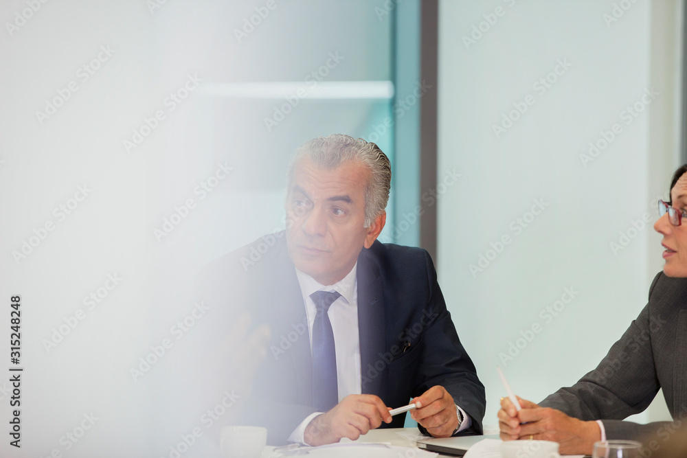 © Robert Daly/Caia Image - Attentive senior businessman listening in conference room meeting