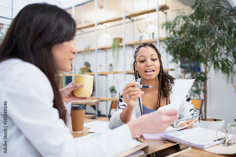 © Sam Edwards/Caia Image - Businesswomen discussing paperwork in office © Sam Edwards/Caia Image - Businesswomen discussing paperwork in office