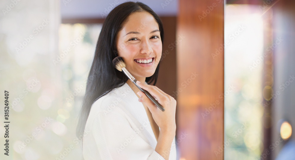 Portrait confident young woman applying makeup Portrait confident young woman applying makeup