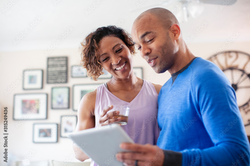 Happy couple using digital tablet