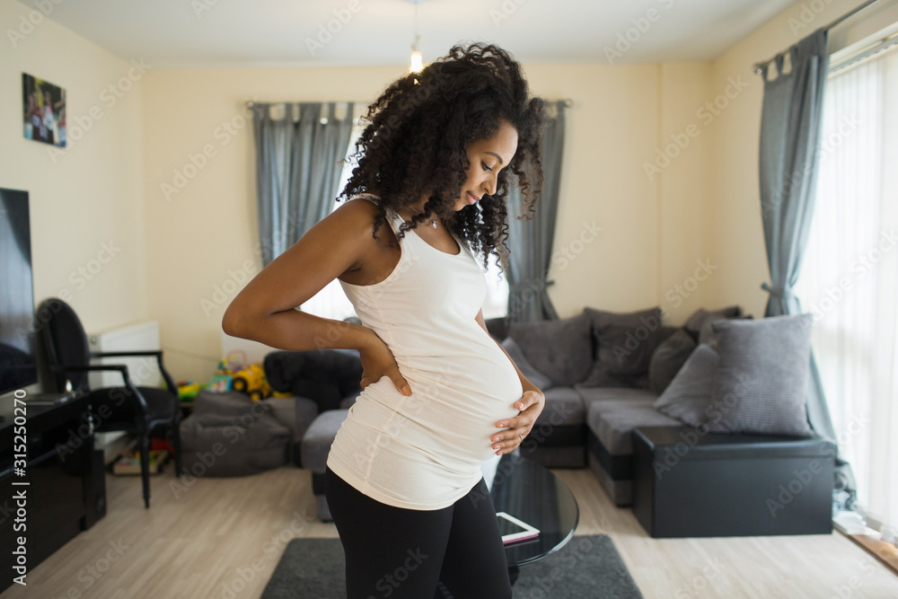 Beautiful young pregnant woman holding stomach Beautiful young pregnant woman holding stomach