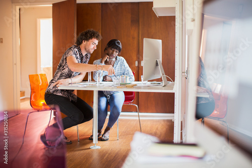 Young multiethnic couple working in home office