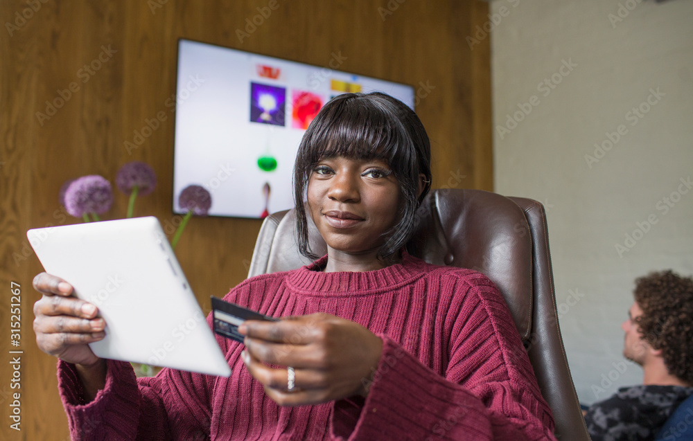 Portrait young woman online shopping with digital tablet and credit card Portrait young woman online shopping with digital tablet and credit card
