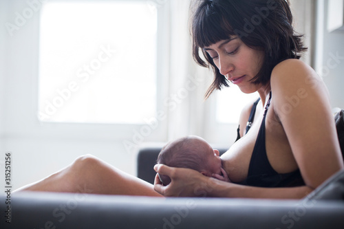 Mother breastfeeding newborn baby son