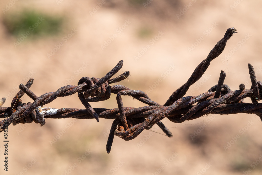 Old barbed wire that has been used to rust Old barbed wire that has been used to rust