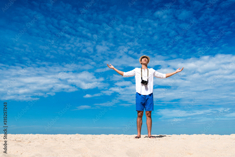 Young man travel outdoor on tropical beach with blue sky and white cloud using DSLR professional camera take a photo on vacation time with love nature. Outdoor travel lifestyle concept. Young man travel outdoor on tropical beach with blue sky and white cloud using DSLR professional camera take a photo on vacation time with love nature. Outdoor travel lifestyle concept.