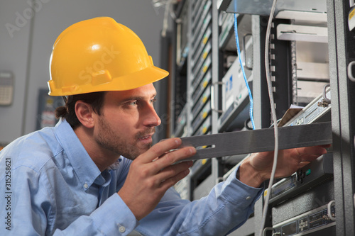 Network engineer installing equipment