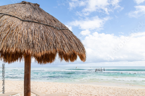 Fototapeta Naklejka Na Ścianę i Meble -  Coconut Palm Leaf Beach Umbrella With Blue Sky and Copy Space