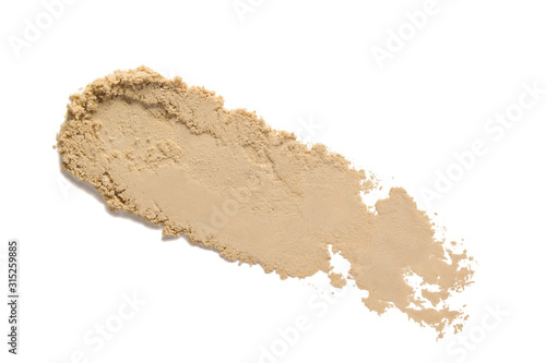 Face powder smear smudge swatch isolated on white background. Beige color makeup foundation sample. Cosmetic powder texture