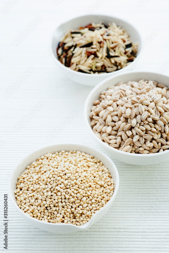 Barley, rice and quinoa in bowls Barley, rice and quinoa in bowls