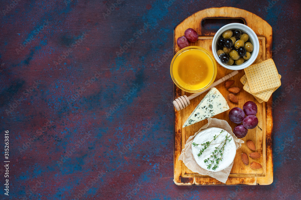 Cheese, honey and fruit on a table. Selective focus. Top view. Copy space. Cheese, honey and fruit on a table. Selective focus. Top view. Copy space.