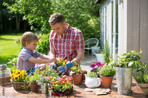 Father and son potting up plants