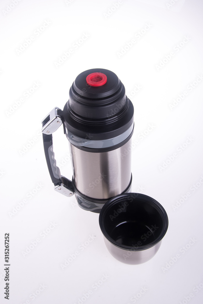 Thermo or Thermo flask from stainless steel on background new. Thermo or Thermo flask from stainless steel on background new.