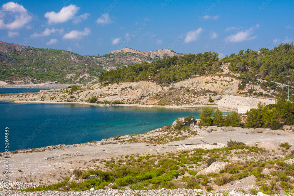 turquoise lake surrounded by mountains on the island of Rhodes