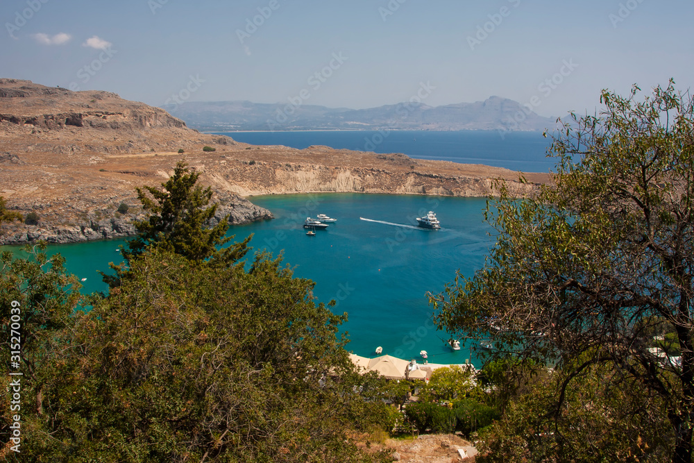 Naklejka premium calm turquoise water of the bay washing the island of Rhodes