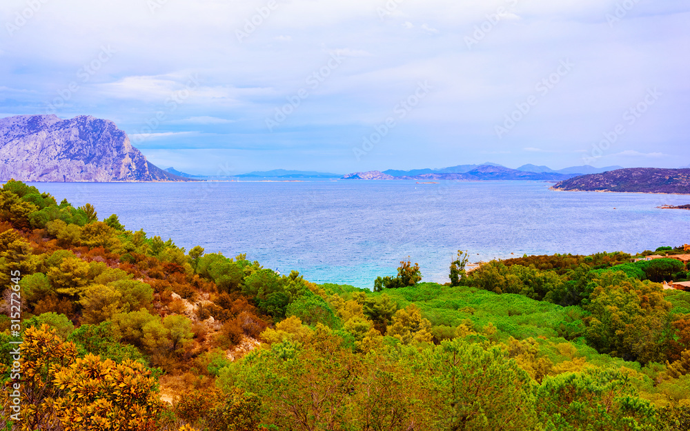 Landscape of Capo Coda Cavallo seen from San Teodoro in the Mediterranean sea in Olbia-Tempio province, Sardinia island, Italy in summer. Scenery at Tavolara Island. Mixed media.