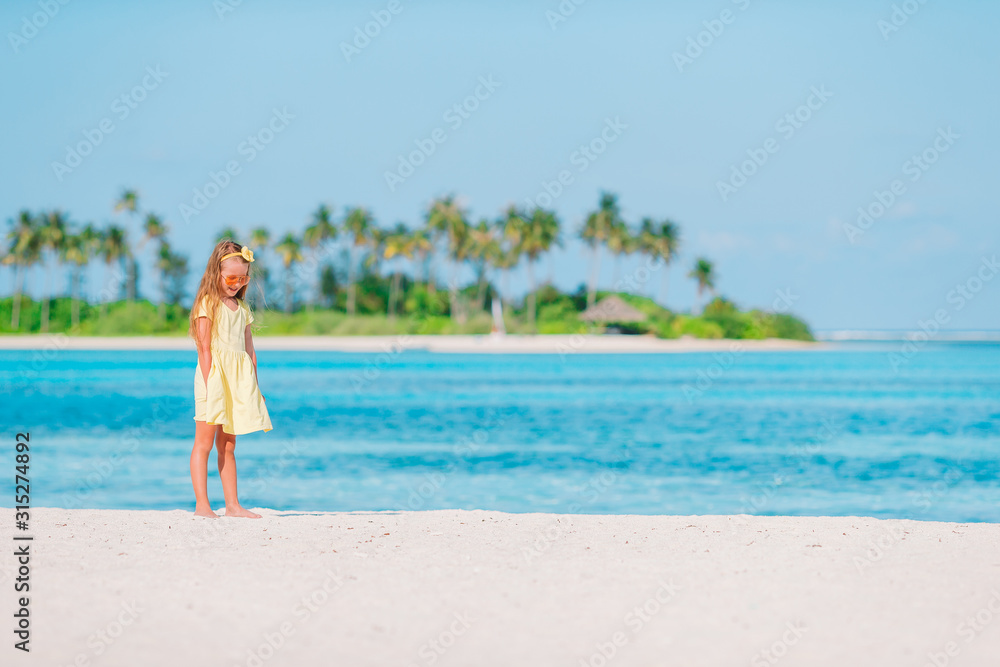 Portrait of adorable little girl at beach on her summer vacation Portrait of adorable little girl at beach on her summer vacation