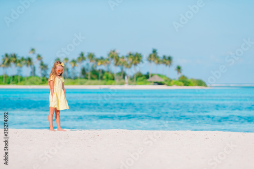 Portrait of adorable little girl at beach on her summer vacation © travnikovstudio