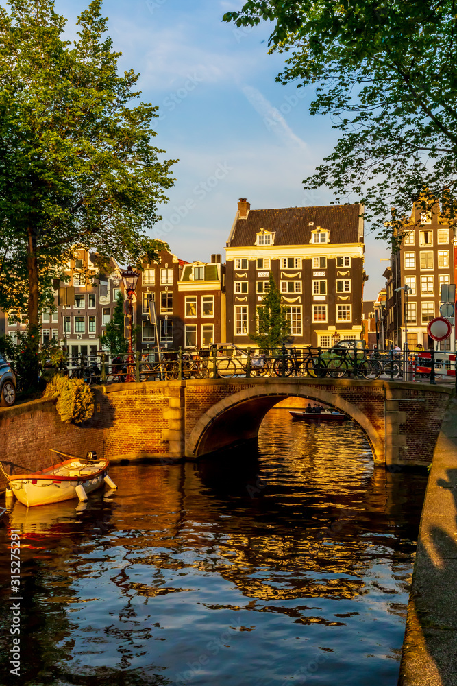 Obraz premium Beautiful view of a bridge over a canal in Amsterdam, Netherlands.