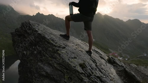 4K Man Looks at Transfagarasan Highway Glacier Lake Romania Sunrise