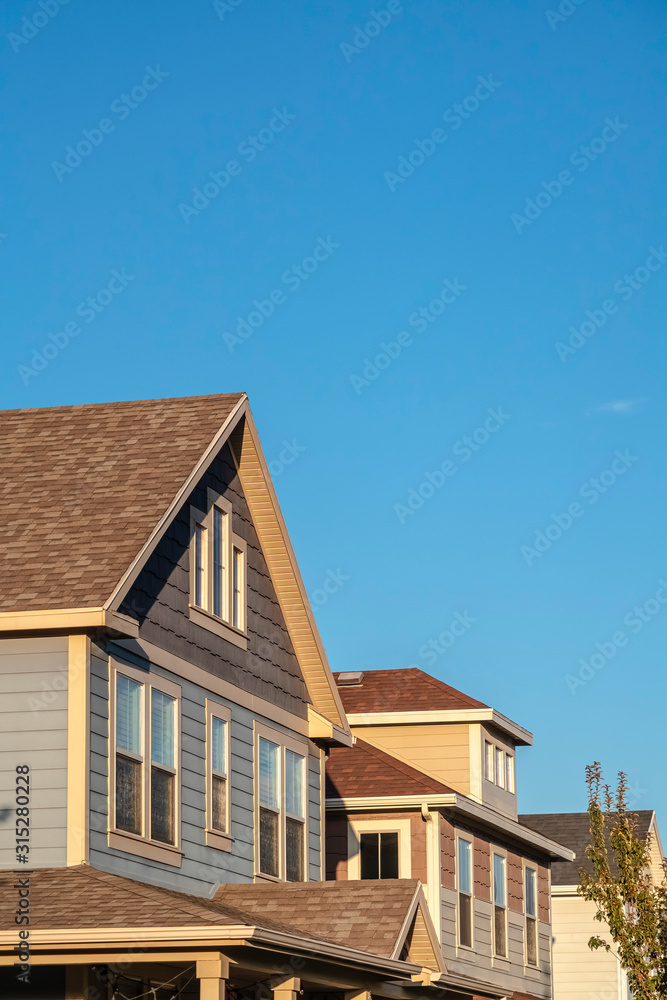Upper facades of a row of timber clad houses Upper facades of a row of timber clad houses
