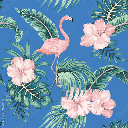 Tropical pink hibiscus and flamingo floral green palm leaves seamless pattern blue background. Exotic jungle wallpaper.