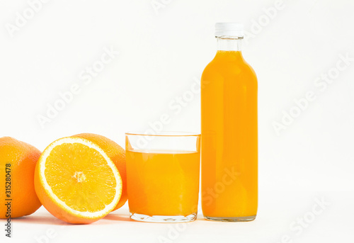 glass of orange juice and oranges Battle of orange juice