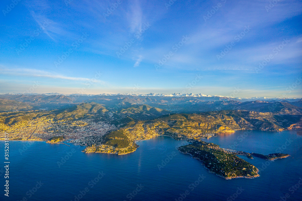 A view from the high at sunrise on the Cote d'azur, the famous Cape Ferrat, the city of Nice and the Maritime Alps, France.