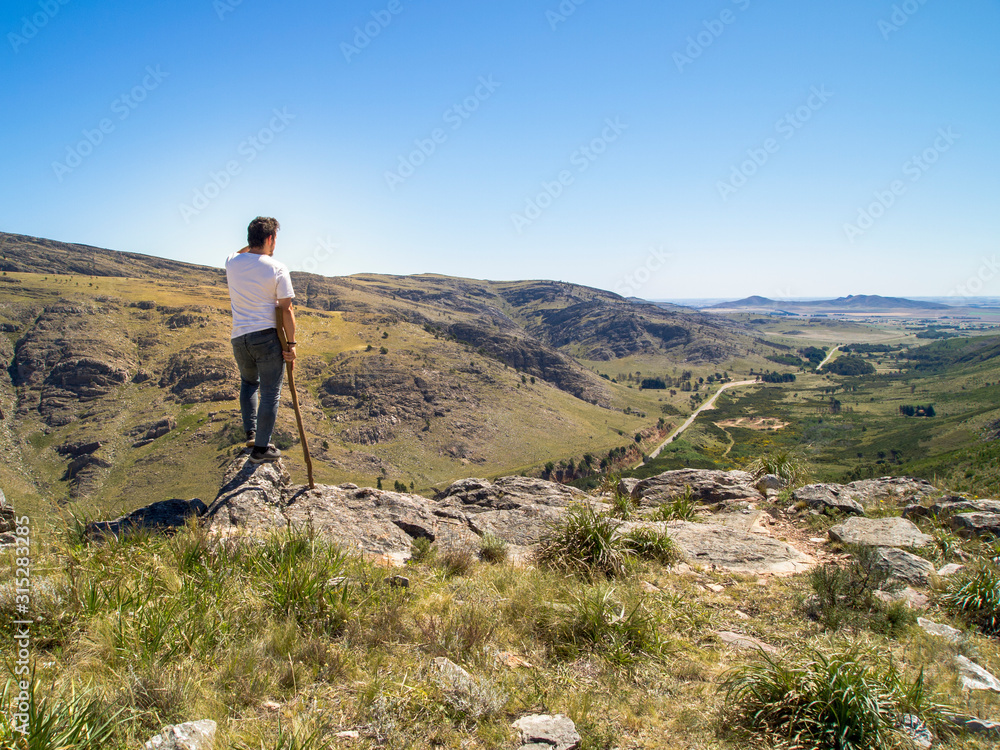 Fototapeta premium Young hiker looking at the view in Cerro Bahía Blanca