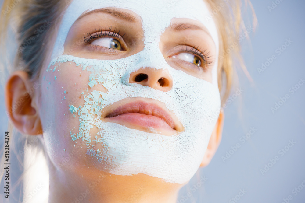 Girl removes dry white mud mask Girl removes dry white mud mask