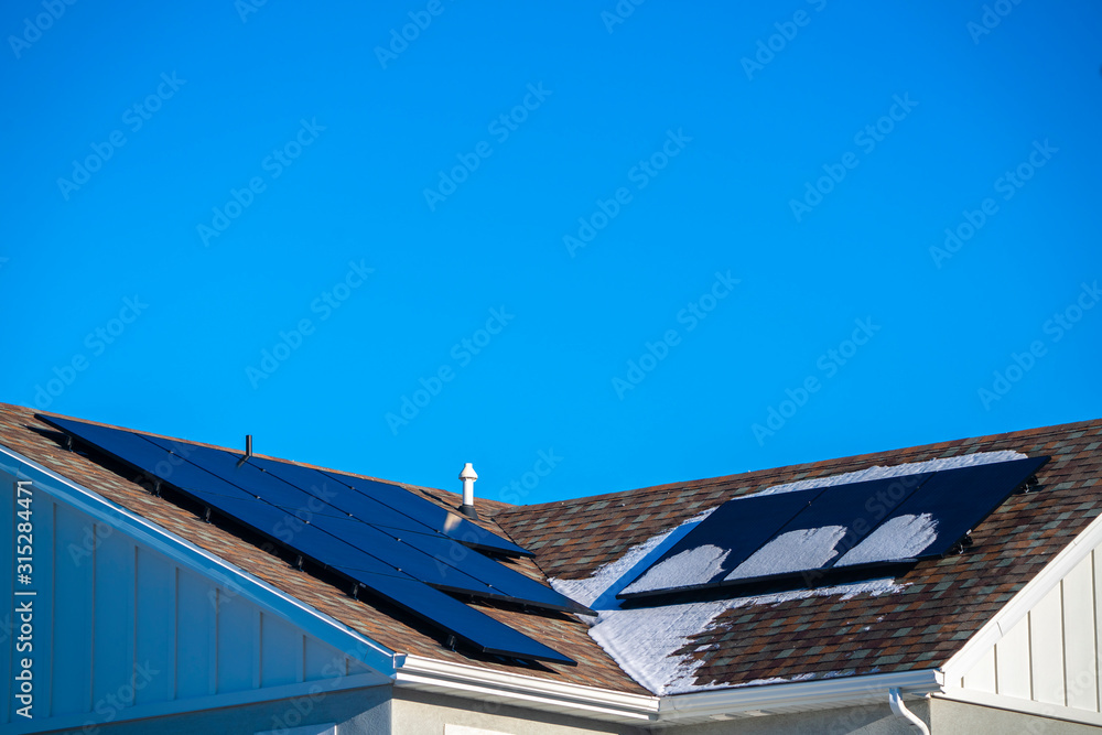 Snow and photovoltaic solar panels on a roof Snow and photovoltaic solar panels on a roof